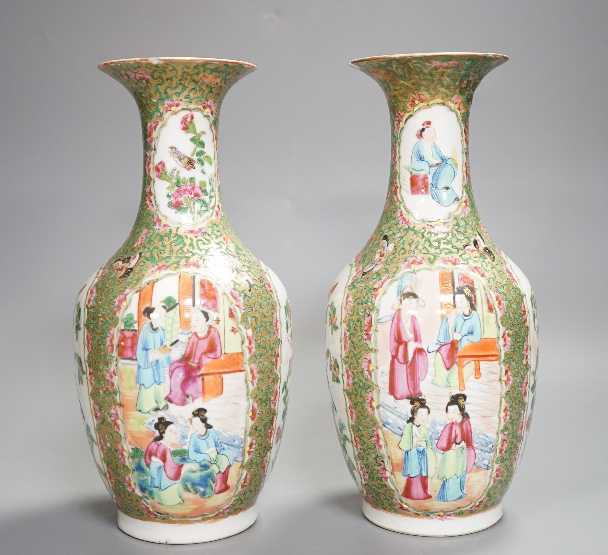 A pair of 19th century Chinese famille rose vases, 24 cms high.